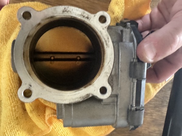 Carbon-fouled throttle body before cleaning